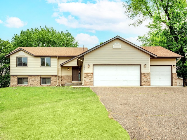 7808 Sunkist Blvd, Brooklyn Park, MN 55444 - tri-level home featuring a garage, driveway, brick siding, a front lawn, and roof with shingles