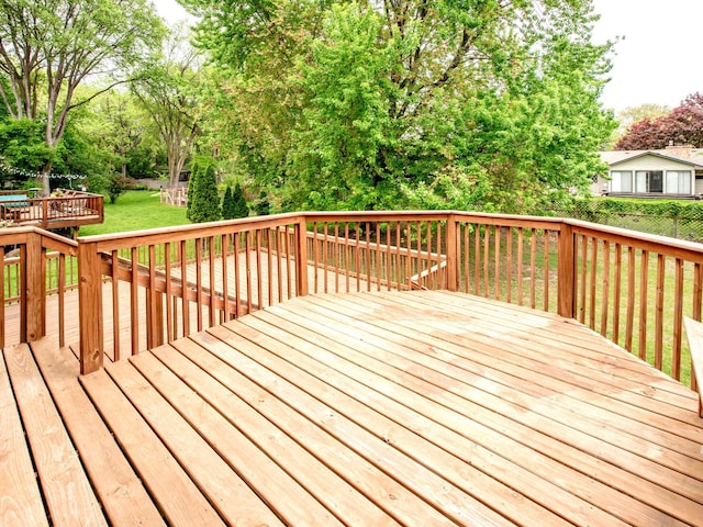 7808 Sunkist Blvd, Brooklyn Park, MN 55444 - deck featuring a lawn and view of scattered trees