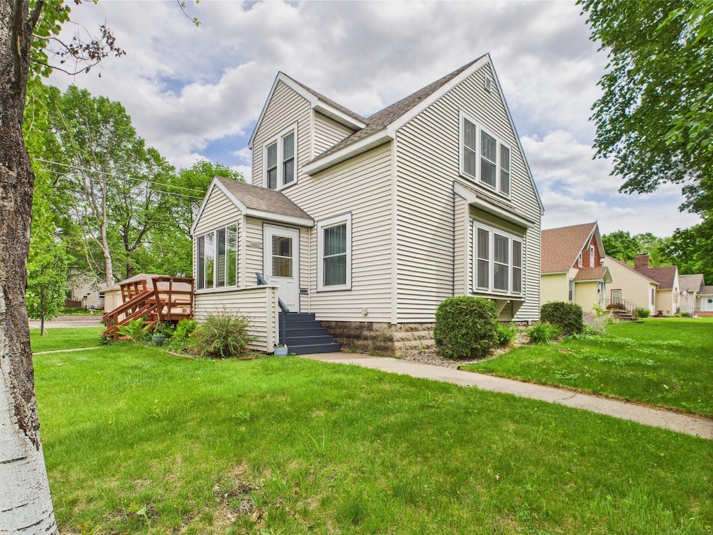 203 2nd Ave SE, Glenwood, MN 56334 - view of front of property with a front lawn, a deck, and a shingled roof
