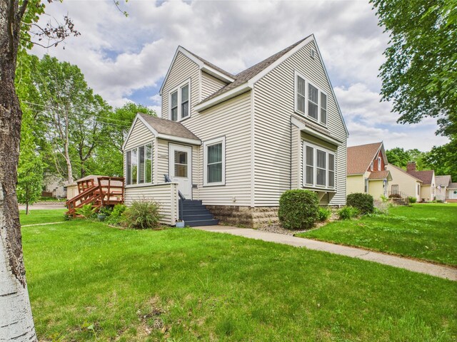 203 2nd Ave SE, Glenwood, MN 56334 - view of front of property with a front lawn, a deck, and a shingled roof