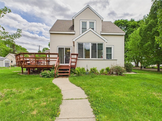 203 2nd Ave SE, Glenwood, MN 56334 - view of front of house featuring a wooden deck, a front yard, and a shingled roof