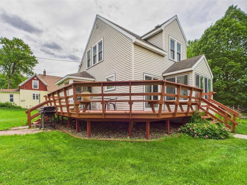 203 2nd Ave SE, Glenwood, MN 56334 - rear view of property with a yard, a deck, and roof with shingles