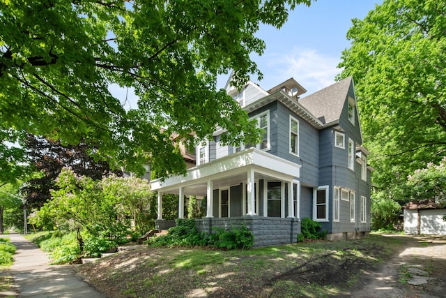 709 7th St SE, Minneapolis, MN 55414 - view of property exterior featuring a porch and a shingled roof