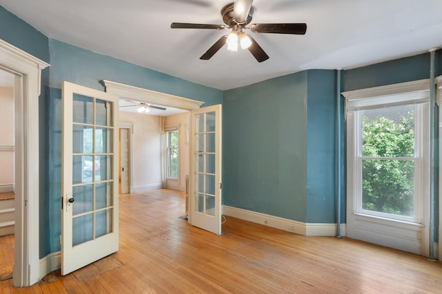 709 7th St SE, Minneapolis, MN 55414 - empty room with french doors, hardwood / wood-style flooring, a ceiling fan, and baseboards