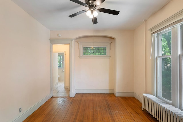 709 7th St SE, Minneapolis, MN 55414 - spare room with radiator heating unit, plenty of natural light, baseboards, and hardwood / wood-style flooring