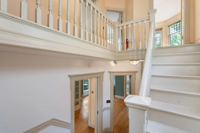 709 7th St SE, Minneapolis, MN 55414 - stairway featuring wood finished floors and a towering ceiling