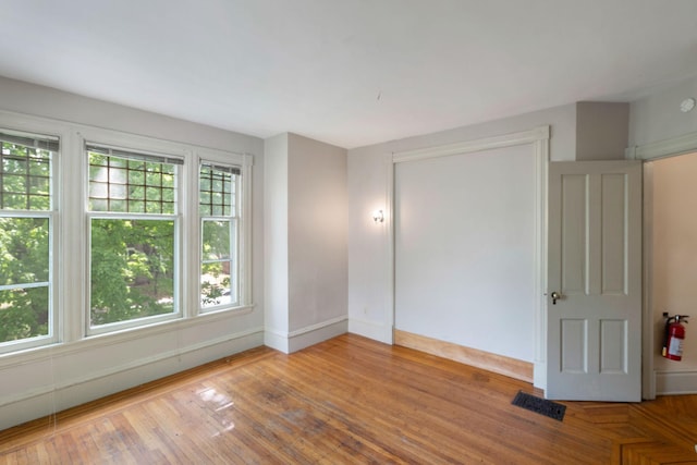 709 7th St SE, Minneapolis, MN 55414 - unfurnished bedroom featuring baseboards and wood finished floors