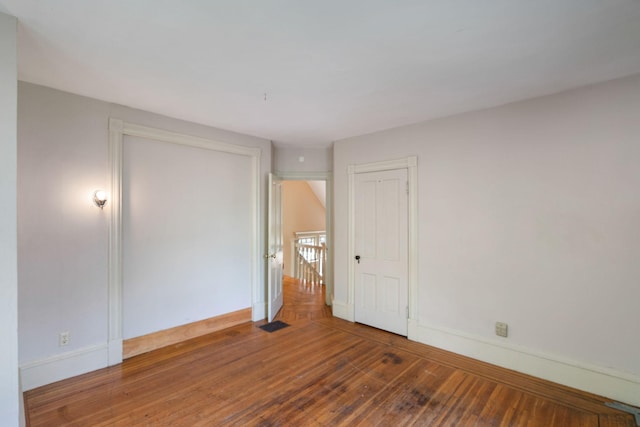 709 7th St SE, Minneapolis, MN 55414 - unfurnished bedroom featuring baseboards and hardwood / wood-style flooring