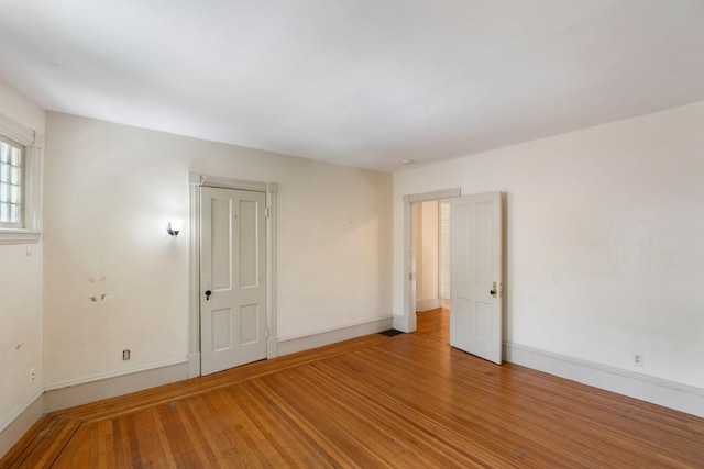 709 7th St SE, Minneapolis, MN 55414 - unfurnished room featuring baseboards and light wood-type flooring