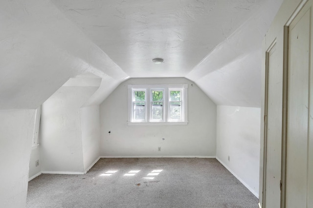 709 7th St SE, Minneapolis, MN 55414 - additional living space featuring carpet flooring, vaulted ceiling, and baseboards