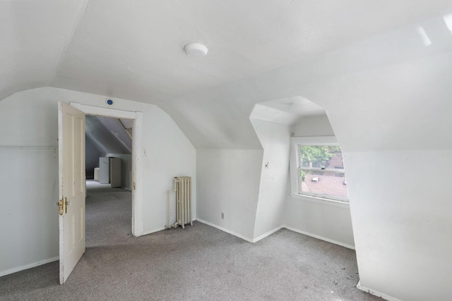 709 7th St SE, Minneapolis, MN 55414 - bonus room featuring radiator, vaulted ceiling, carpet floors, and baseboards