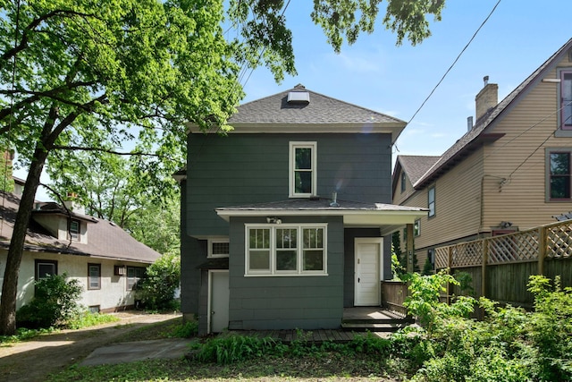 709 7th St SE, Minneapolis, MN 55414 - rear view of property with a shingled roof and fence