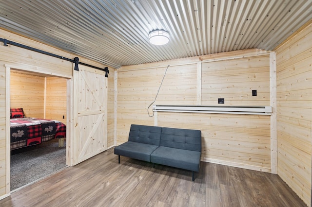 24625 Fosmo Dr, La Follette Twp, WI 54893 - sitting room featuring a barn door, wood finished floors, and wooden walls