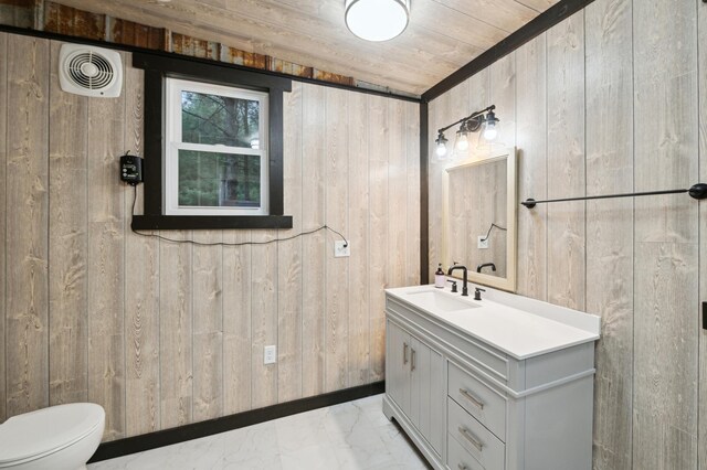 24625 Fosmo Dr, La Follette Twp, WI 54893 - bathroom with wooden walls, marble finish flooring, vanity, toilet, and wooden ceiling