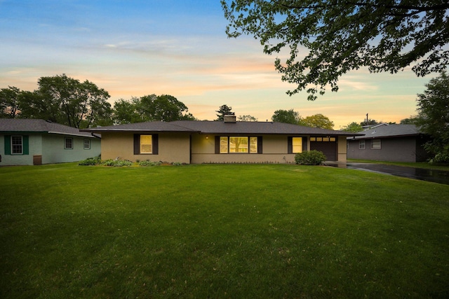 8007 5th St NE, Spring Lake Park, MN 55432 - ranch-style house with an attached garage, asphalt driveway, a lawn, and a chimney