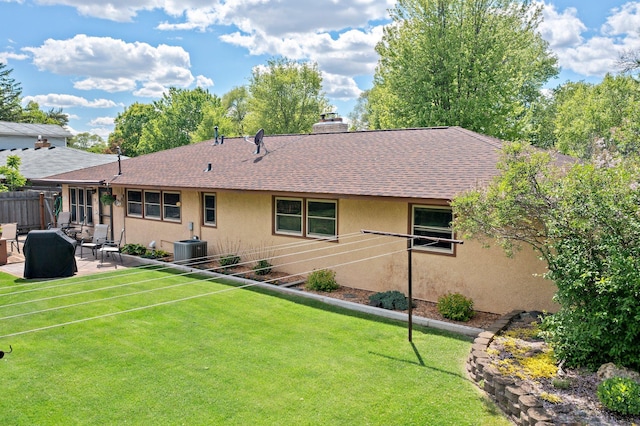 8007 5th St NE, Spring Lake Park, MN 55432 - back of property with roof with shingles, a patio area, stucco siding, a chimney, and central AC unit