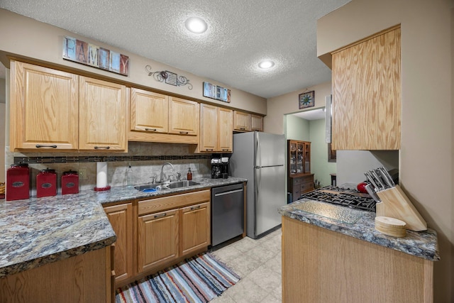 8007 5th St NE, Spring Lake Park, MN 55432 - kitchen with stainless steel appliances, a textured ceiling, a sink, backsplash, and light floors