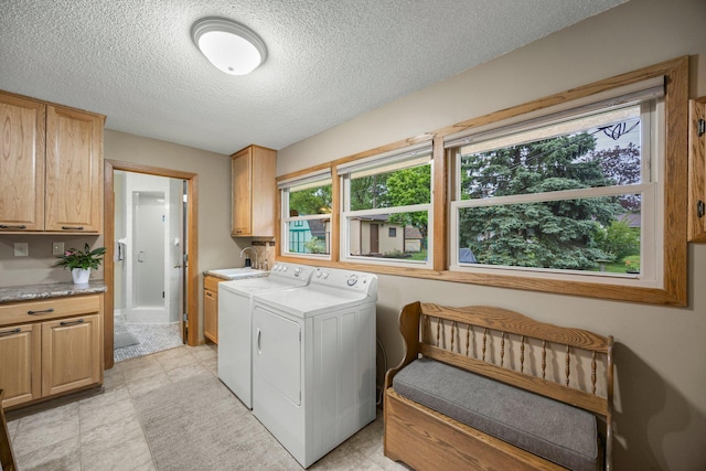 8007 5th St NE, Spring Lake Park, MN 55432 - washroom with cabinet space, washer and dryer, and a textured ceiling