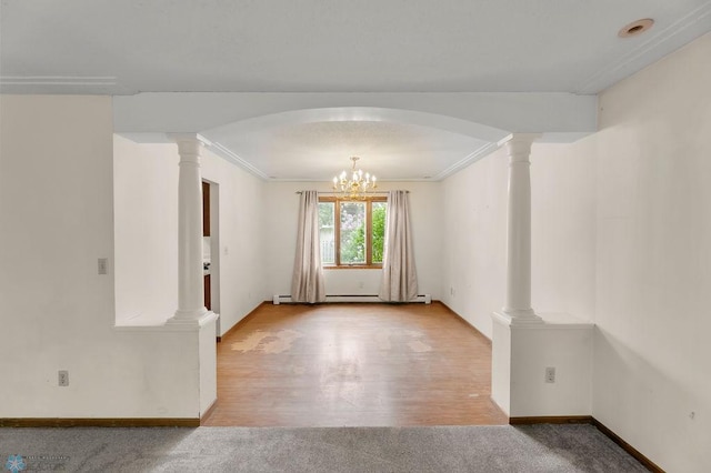 3667 Evergreen Rd N, Fargo, ND 58102 - spare room featuring a chandelier, decorative columns, baseboards, ornamental molding, and wood finished floors