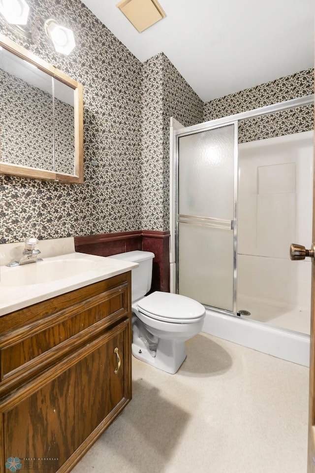 3667 Evergreen Rd N, Fargo, ND 58102 - full bathroom featuring wallpapered walls, wainscoting, vanity, a stall shower, and toilet