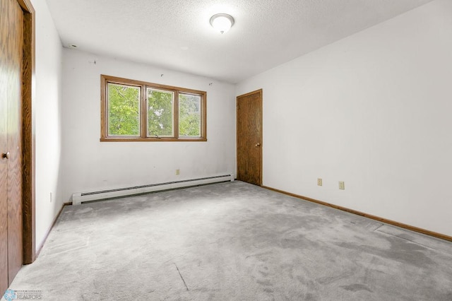 3667 Evergreen Rd N, Fargo, ND 58102 - carpeted spare room with a baseboard heating unit, baseboards, and a textured ceiling