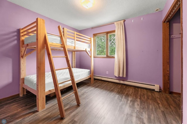 3667 Evergreen Rd N, Fargo, ND 58102 - unfurnished bedroom featuring baseboard heating, wood finished floors, and a textured ceiling