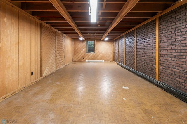 3667 Evergreen Rd N, Fargo, ND 58102 - below grade area featuring a baseboard heating unit, wooden walls, and brick wall