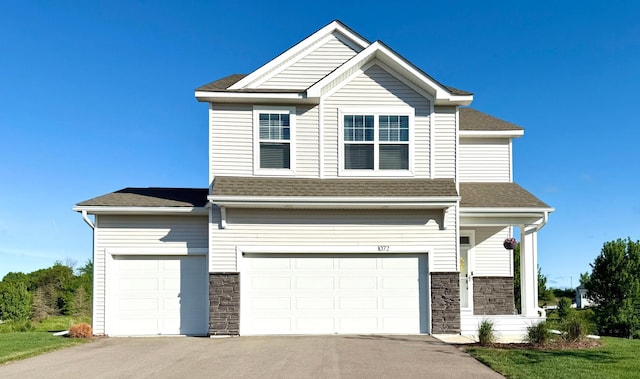 1072 Shoreview Dr, Jordan, MN 55352 - view of front facade with stone siding, roof with shingles, and driveway