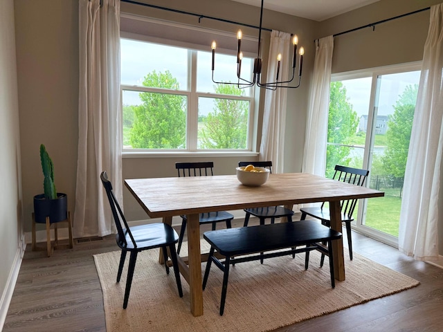 1072 Shoreview Dr, Jordan, MN 55352 - dining area with a chandelier, wood finished floors, and baseboards