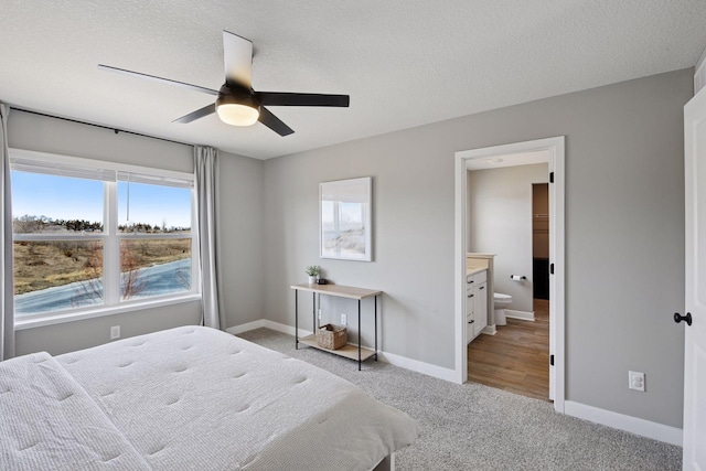 1072 Shoreview Dr, Jordan, MN 55352 - bedroom with light colored carpet, baseboards, ensuite bath, a ceiling fan, and a textured ceiling