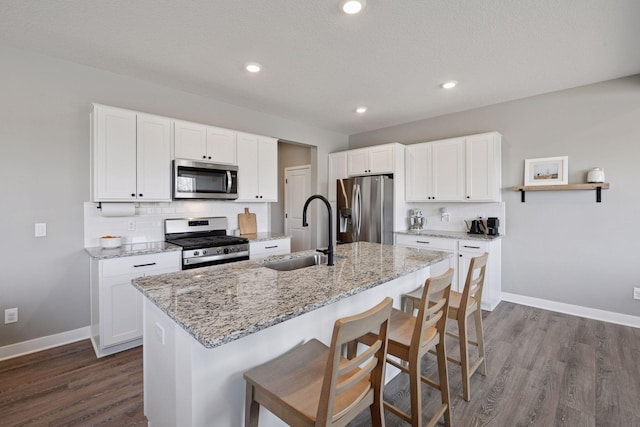 1072 Shoreview Dr, Jordan, MN 55352 - kitchen featuring appliances with stainless steel finishes, a sink, dark wood finished floors, decorative backsplash, and recessed lighting