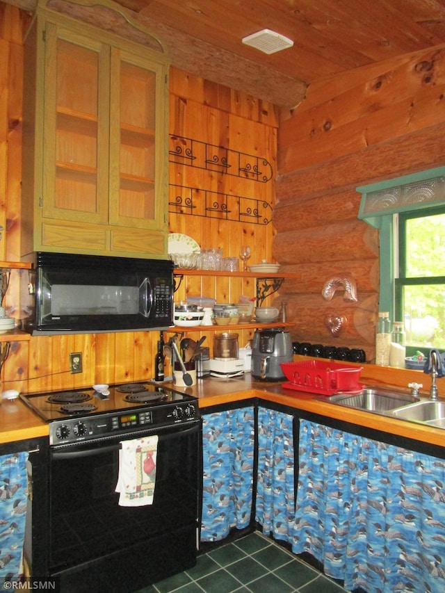 kitchen with black appliances, a sink, log walls, dark tile patterned flooring, and wooden ceiling