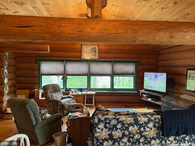 living area featuring rustic walls, healthy amount of natural light, wood finished floors, beamed ceiling, and wooden ceiling