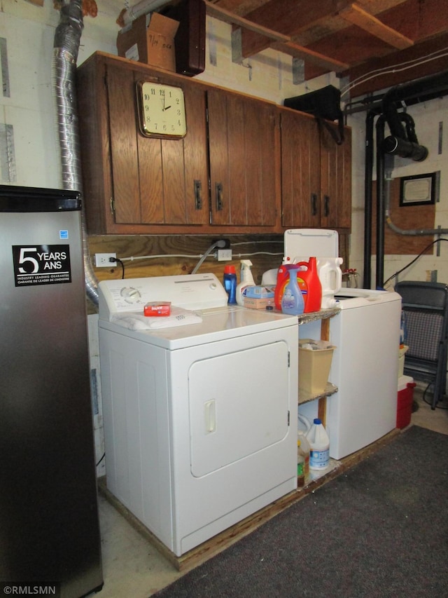 clothes washing area featuring independent washer and dryer