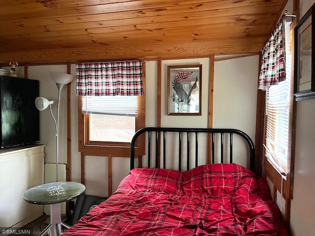 bedroom featuring multiple windows and wooden ceiling