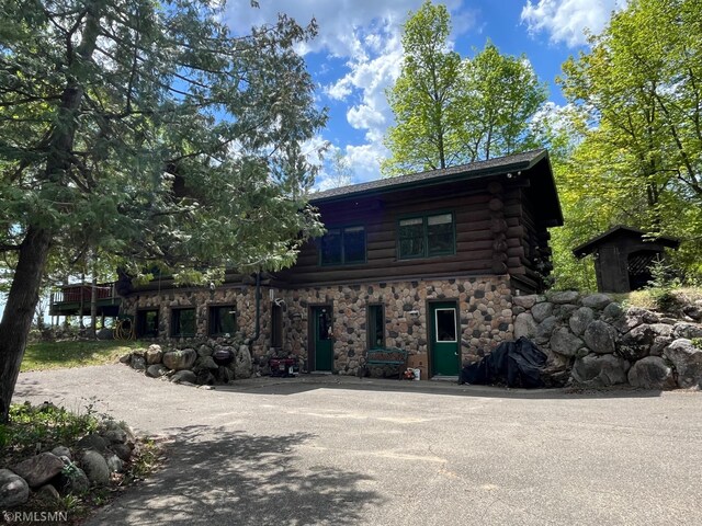 4701 Shangri La Dr NE, Wabedo Twp, MN 56655 - view of front of home with log siding and stone siding