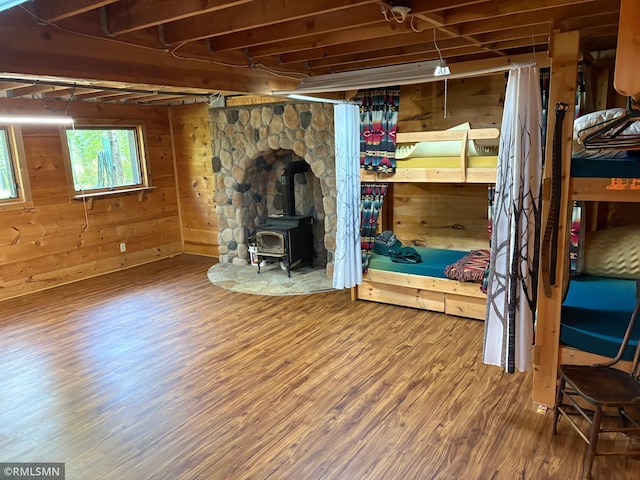 4701 Shangri La Dr NE, Wabedo Twp, MN 56655 - basement with wood finished floors, a wood stove, and wood walls