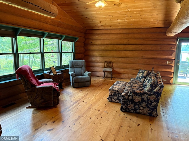 4701 Shangri La Dr NE, Wabedo Twp, MN 56655 - living area with wood-type flooring, lofted ceiling, wooden ceiling, and rustic walls