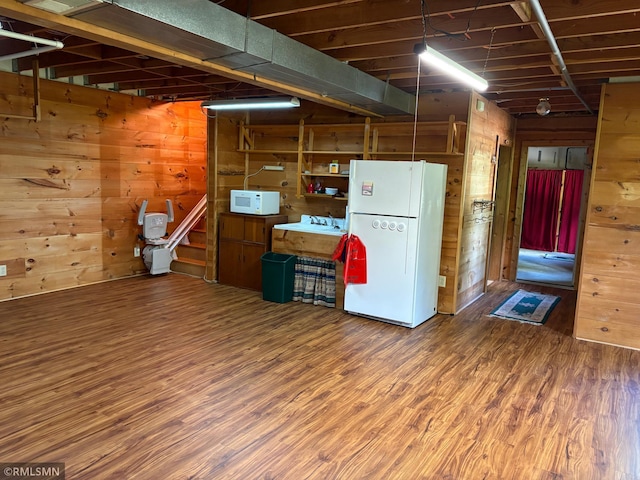 4701 Shangri La Dr NE, Wabedo Twp, MN 56655 - below grade area featuring freestanding refrigerator, wood finished floors, and wooden walls
