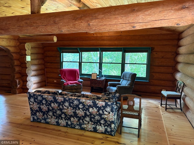4701 Shangri La Dr NE, Wabedo Twp, MN 56655 - living area featuring beamed ceiling, wood-type flooring, plenty of natural light, and log walls