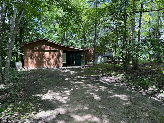 4701 Shangri La Dr NE, Wabedo Twp, MN 56655 - view of front of home with an outdoor structure and a garage
