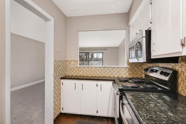 2200 Nevada Ave S Unit 313, Saint Louis Park, MN 55426 - kitchen with appliances with stainless steel finishes, white cabinets, dark stone countertops, and backsplash