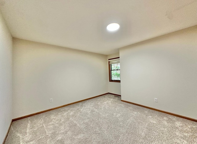 empty room with carpet flooring and baseboards