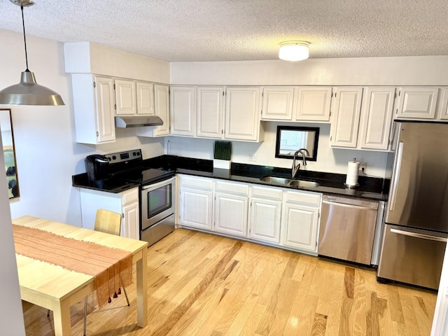3568 Cloman Way, Inver Grove Heights, MN 55076 - kitchen featuring appliances with stainless steel finishes, a sink, under cabinet range hood, a textured ceiling, and light wood-style floors