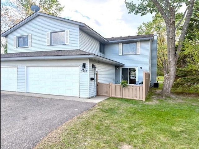 3568 Cloman Way, Inver Grove Heights, MN 55076 - traditional-style home featuring a garage and asphalt driveway