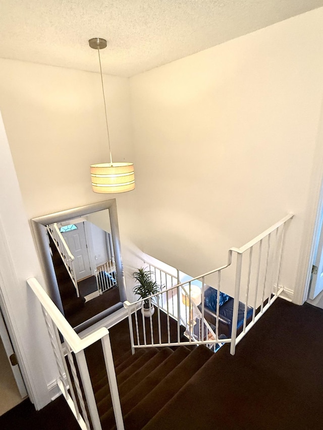 3568 Cloman Way, Inver Grove Heights, MN 55076 - stairway featuring a textured ceiling and wood finished floors