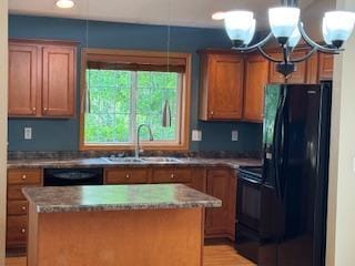 5047 Florence Dr NW, Rochester, MN 55901 - kitchen with black appliances, a sink, brown cabinets, a center island, and decorative light fixtures