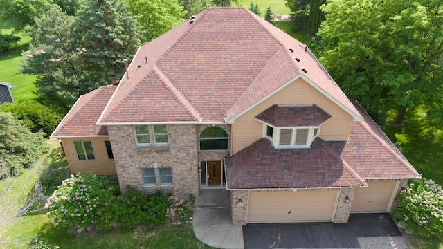 2505 Christian Dr, Chaska, MN 55318 - view of front facade with brick siding, asphalt driveway, and a shingled roof