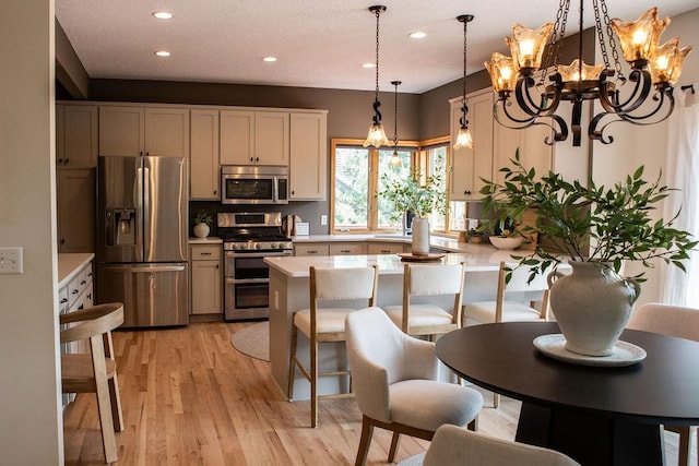 2505 Christian Dr, Chaska, MN 55318 - kitchen featuring appliances with stainless steel finishes, light countertops, recessed lighting, a chandelier, and a peninsula