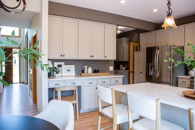 2505 Christian Dr, Chaska, MN 55318 - kitchen featuring light wood finished floors, stainless steel fridge, light countertops, pendant lighting, and recessed lighting